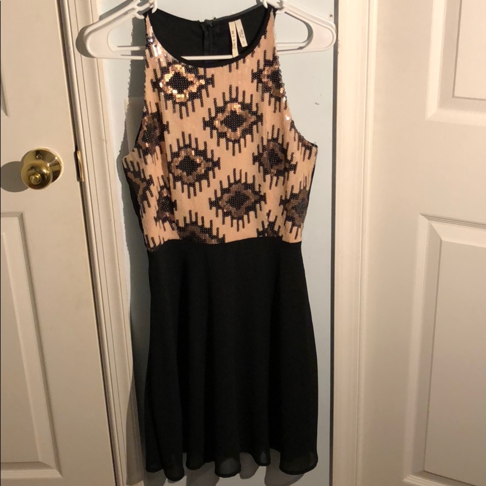Elegant little black dress with a sequined top